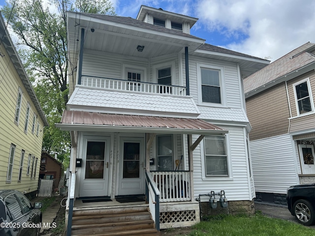 view of front facade featuring a balcony and a porch