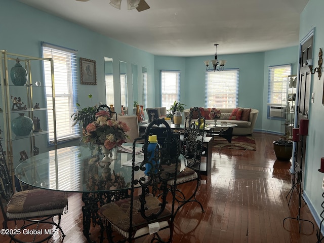 dining room featuring hardwood / wood-style floors, ceiling fan, and a chandelier