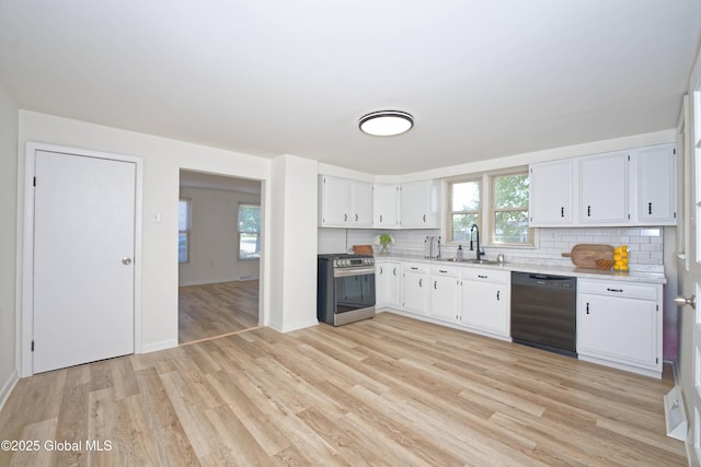 30 Andrewsville Ct, Watervliet, NY 12189 - kitchen featuring black dishwasher, stainless steel range with gas stovetop, a sink, tasteful backsplash, and light wood finished floors