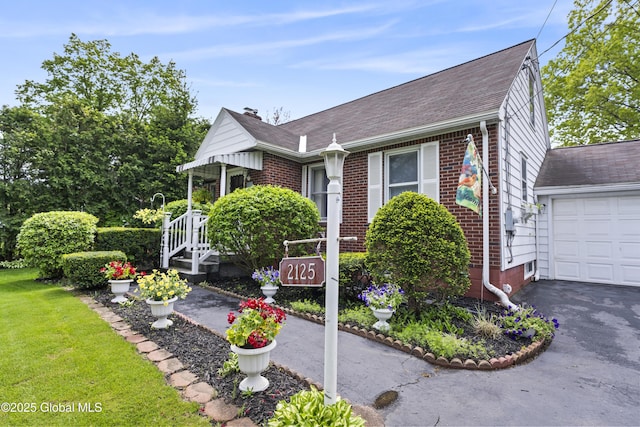 2125 Ferguson St, Rotterdam, NY 12303 - view of front of house featuring brick siding, a shingled roof, a front lawn, asphalt driveway, and a chimney