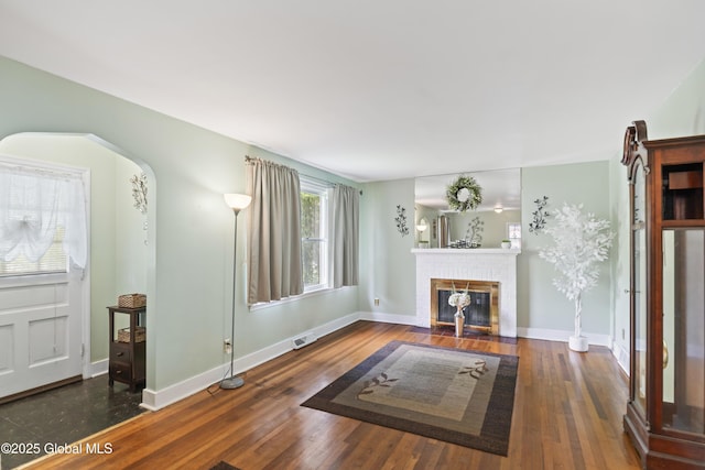 2125 Ferguson St, Rotterdam, NY 12303 - living room featuring hardwood / wood-style floors, a brick fireplace, and baseboards