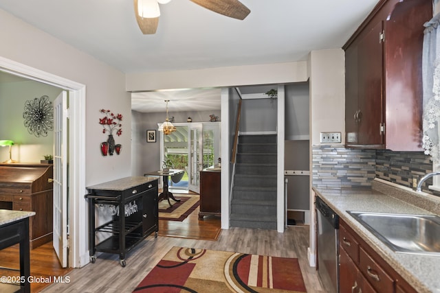 2125 Ferguson St, Rotterdam, NY 12303 - kitchen with dishwasher, wood finished floors, decorative backsplash, a sink, and a ceiling fan