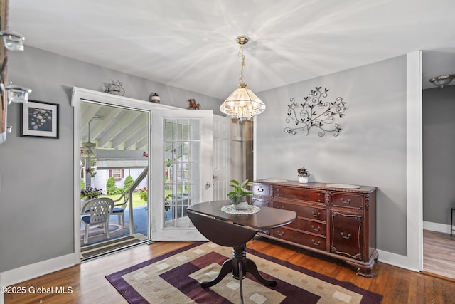 2125 Ferguson St, Rotterdam, NY 12303 - dining area with a chandelier, wood finished floors, and baseboards