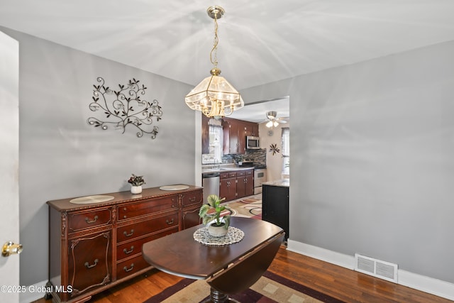 2125 Ferguson St, Rotterdam, NY 12303 - dining space with wood finished floors, ceiling fan, baseboards, and a chandelier