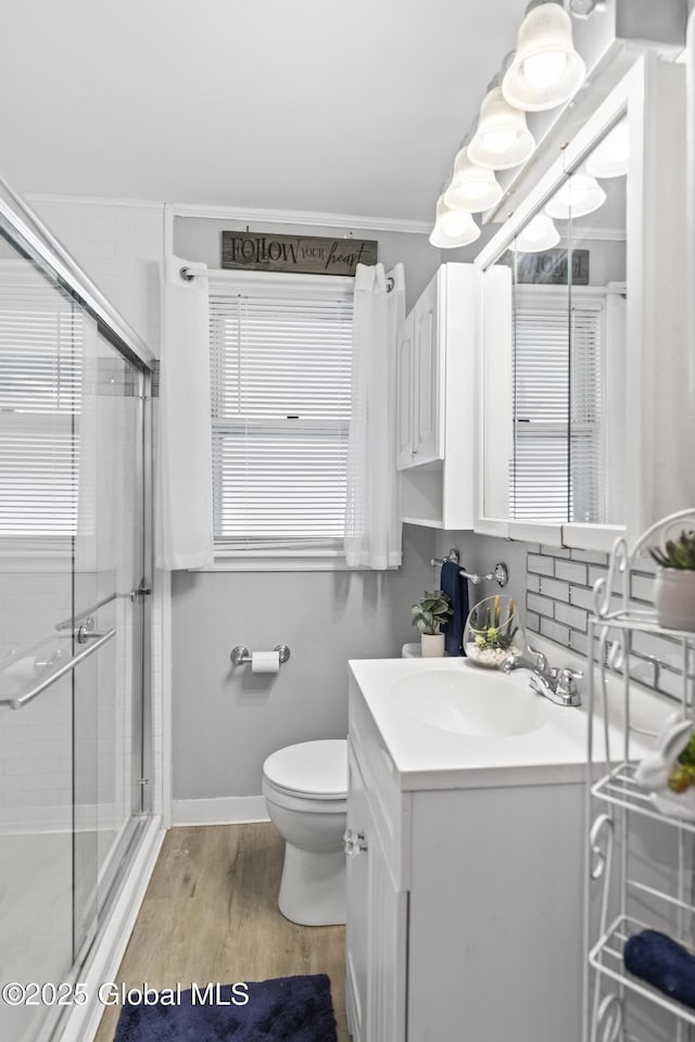 2125 Ferguson St, Rotterdam, NY 12303 - bathroom with a stall shower, healthy amount of natural light, vanity, wood finished floors, and crown molding