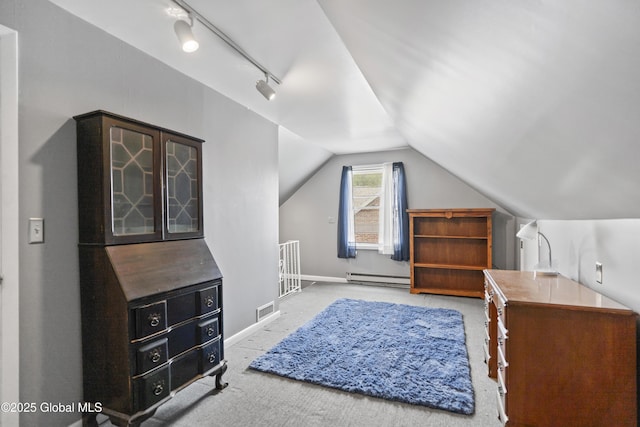 2125 Ferguson St, Rotterdam, NY 12303 - carpeted bedroom with baseboard heating, vaulted ceiling, rail lighting, and baseboards