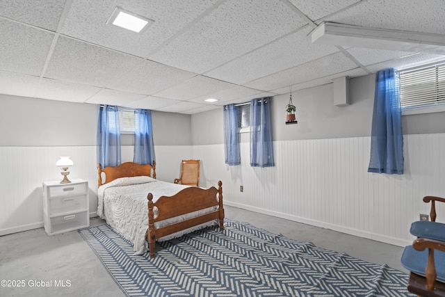 2125 Ferguson St, Rotterdam, NY 12303 - bedroom with wainscoting, a paneled ceiling, concrete floors, and baseboards