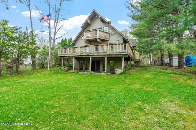 rear view of property featuring a wooden deck and a yard