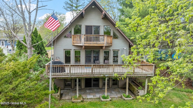 back of house featuring a balcony, a patio area, and a deck