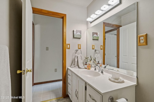 bathroom with vanity, tile patterned floors, and baseboards