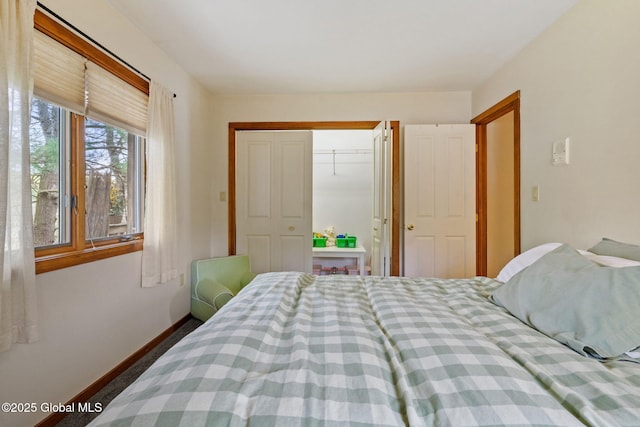bedroom with a closet and baseboards