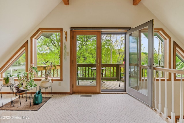 doorway with baseboards and carpet flooring