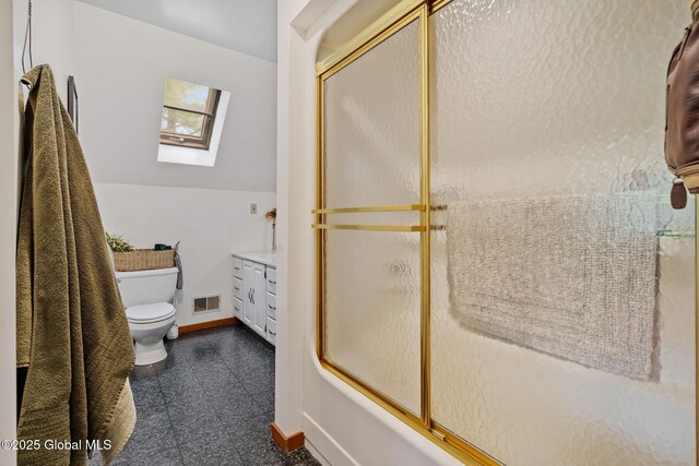 bathroom with a skylight, toilet, baseboards, vanity, and shower / bath combination with glass door