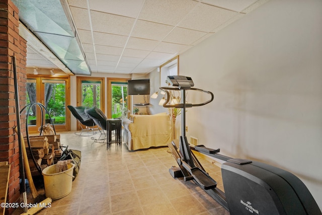 exercise area featuring a paneled ceiling