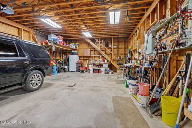 garage with a workshop area and a garage door opener