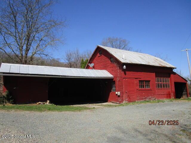 view of outbuilding featuring an outdoor structure and a carport