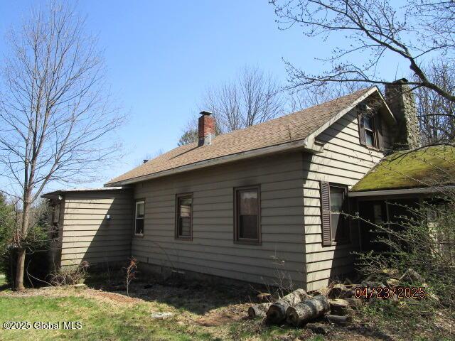 view of property exterior featuring a chimney