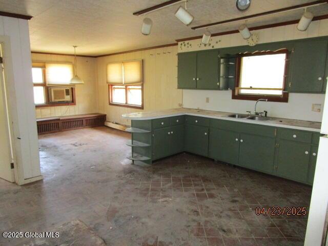 kitchen with green cabinetry, a sink, open shelves, and a baseboard heating unit