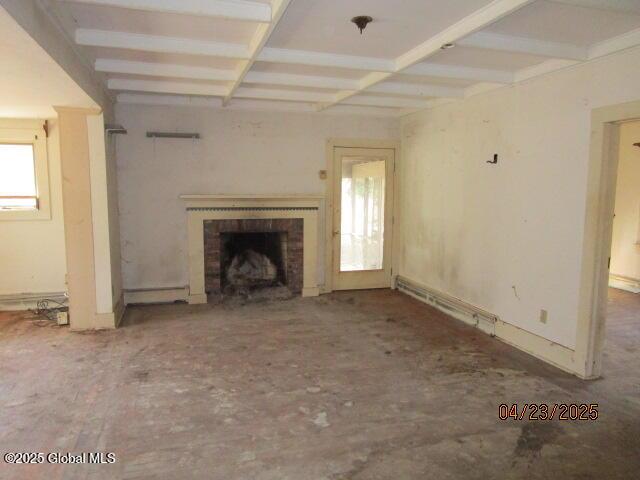 unfurnished living room with baseboard heating, coffered ceiling, a fireplace, and beam ceiling