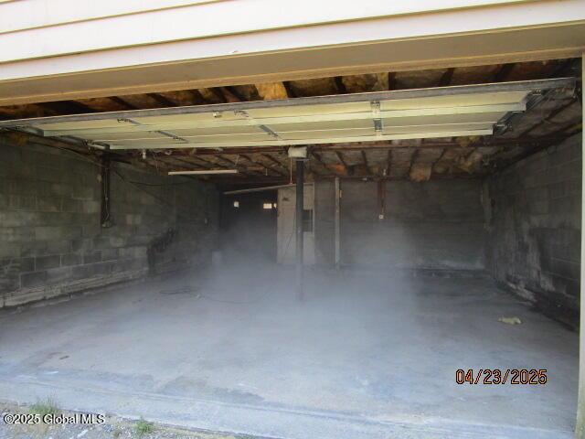garage with concrete block wall