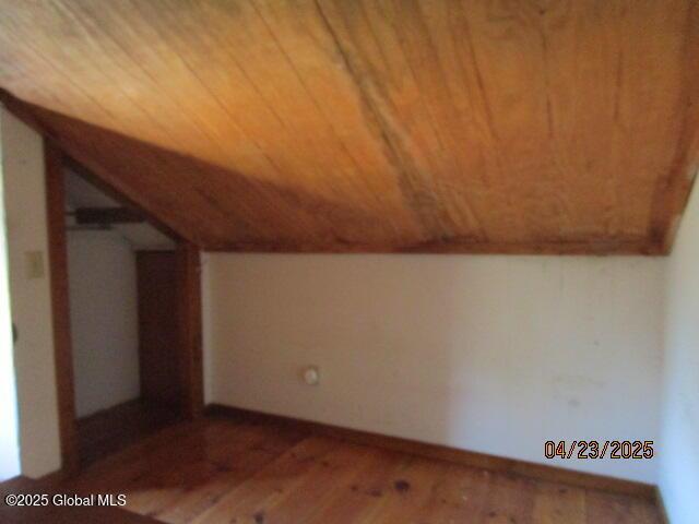 bonus room with wooden ceiling, lofted ceiling, and wood finished floors