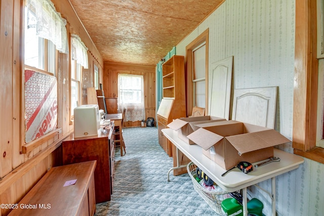 miscellaneous room featuring wallpapered walls and carpet floors