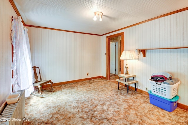 sitting room with ornamental molding and carpet flooring
