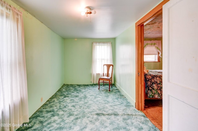living area featuring carpet flooring and healthy amount of natural light