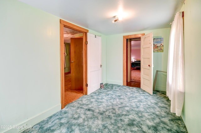 carpeted bedroom featuring baseboards