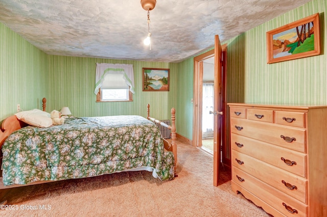bedroom featuring wallpapered walls, light colored carpet, and a textured ceiling