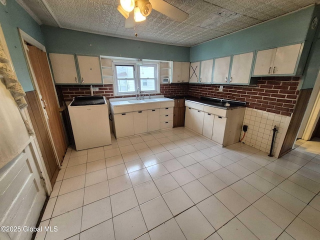 1220 5th Ave, Watervliet, NY 12189 - kitchen featuring ceiling fan, wainscoting, light tile patterned floors, a sink, and brick wall