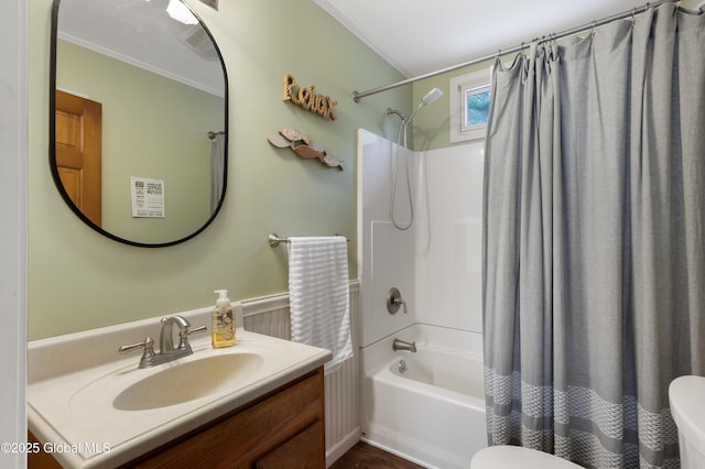 full bath featuring ornamental molding, shower / bath combo with shower curtain, toilet, and vanity