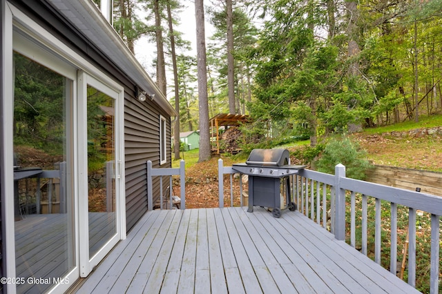 wooden terrace featuring a grill