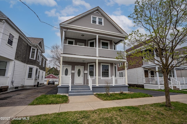 view of front of property featuring a balcony and a porch