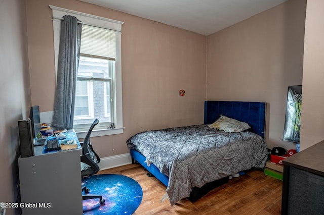 bedroom with wood finished floors, a desk, and baseboards
