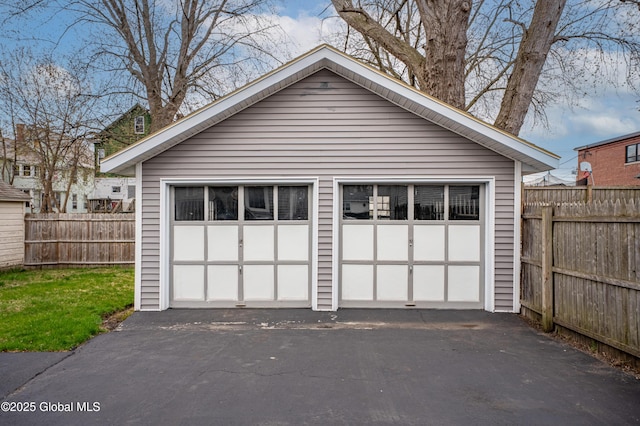detached garage featuring fence