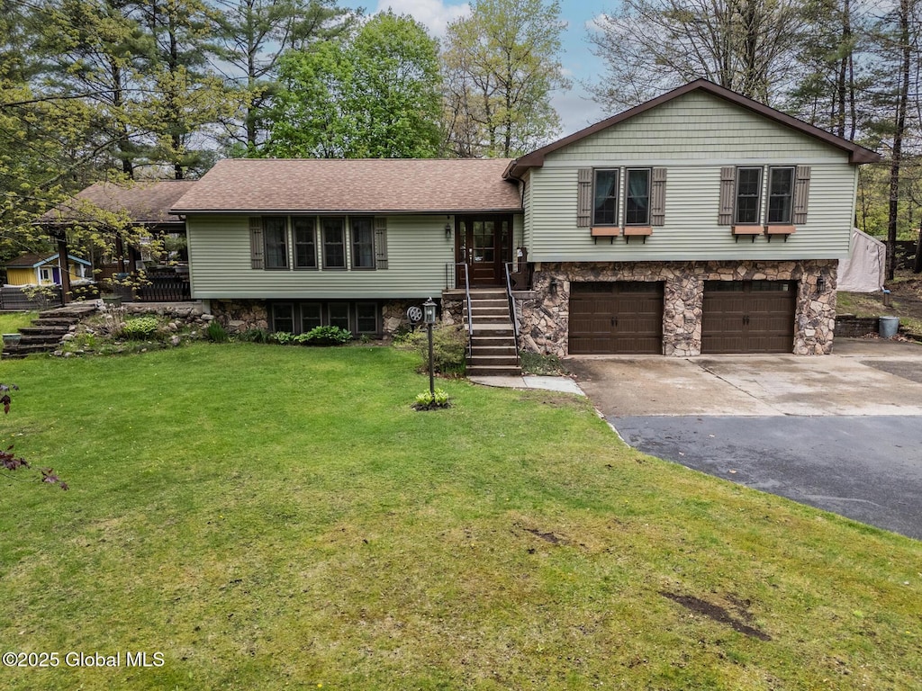 51 Michael Rd, Moreau, NY 12828 - tri-level home with asphalt driveway, an attached garage, a front yard, stairs, and roof with shingles