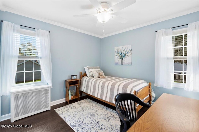 bedroom featuring dark wood-style flooring, radiator heating unit, ornamental molding, baseboards, and a ceiling fan