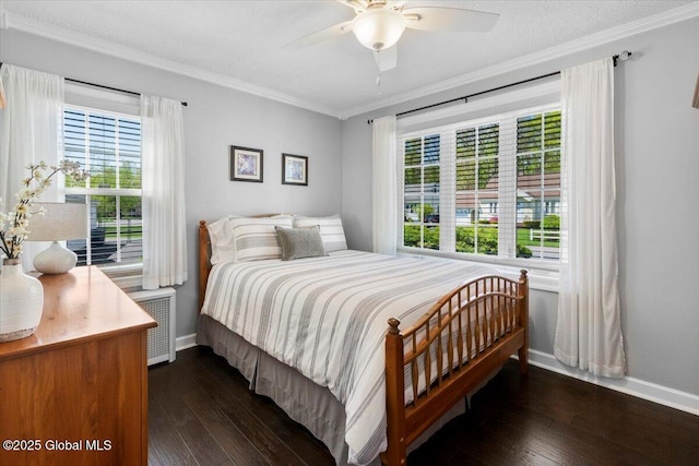 bedroom featuring baseboards, dark wood finished floors, crown molding, and a ceiling fan