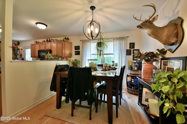 15 Fellows Rd, Halfmoon, NY 12065 - dining area featuring a chandelier, plenty of natural light, light wood-style floors, and baseboards