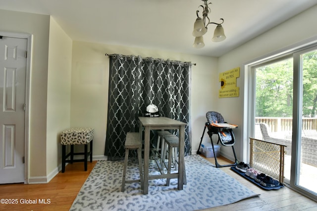 15 Fellows Rd, Halfmoon, NY 12065 - dining room with wood finished floors, a chandelier, and baseboards