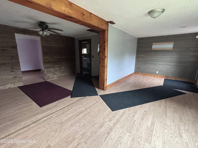 162 State Highway 67, Ephratah, NY 13339 - empty room featuring wooden walls, wood finished floors, ceiling fan, and baseboards