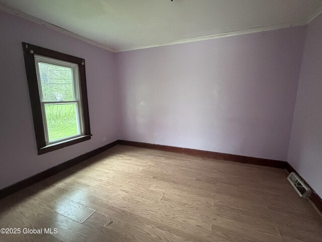 162 State Highway 67, Ephratah, NY 13339 - spare room featuring wood finished floors, baseboards, and crown molding