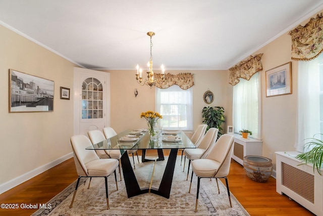 1435 Lowell Rd, Schenectady, NY 12308 - dining space featuring a chandelier, wood finished floors, ornamental molding, radiator heating unit, and baseboards