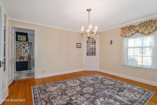 1435 Lowell Rd, Schenectady, NY 12308 - spare room featuring a chandelier, wood finished floors, ornamental molding, and baseboards