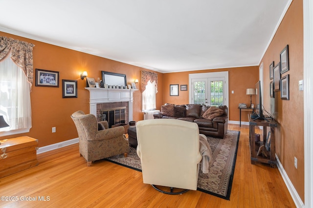 1435 Lowell Rd, Schenectady, NY 12308 - living area featuring light wood finished floors, a fireplace, baseboards, and crown molding