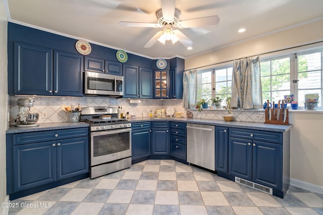 1435 Lowell Rd, Schenectady, NY 12308 - kitchen featuring stainless steel appliances, blue cabinets, dark countertops, crown molding, and recessed lighting