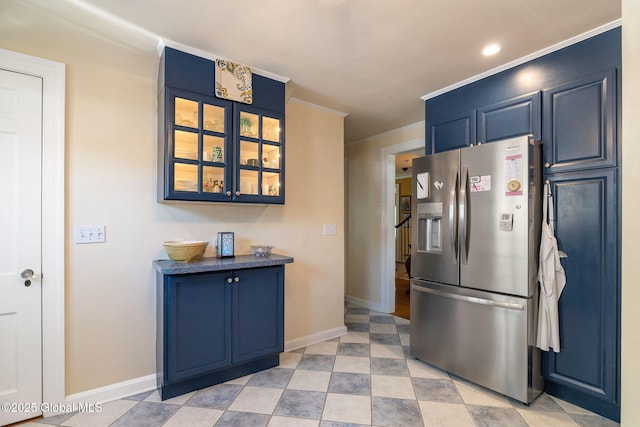 1435 Lowell Rd, Schenectady, NY 12308 - kitchen with stainless steel fridge with ice dispenser, blue cabinetry, glass insert cabinets, crown molding, and baseboards