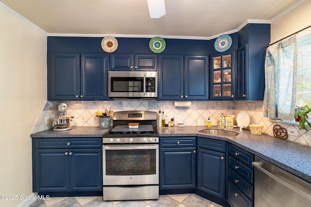 1435 Lowell Rd, Schenectady, NY 12308 - kitchen featuring appliances with stainless steel finishes, a sink, blue cabinetry, dark countertops, and ornamental molding