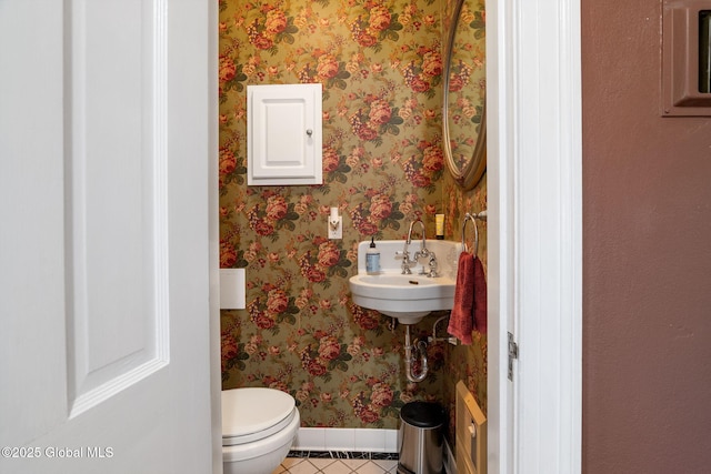 1435 Lowell Rd, Schenectady, NY 12308 - bathroom featuring tile patterned floors, baseboards, toilet, a sink, and wallpapered walls